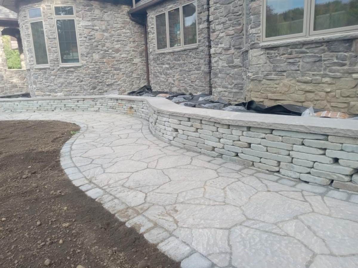 Close view of natural stone patio work at a stone home