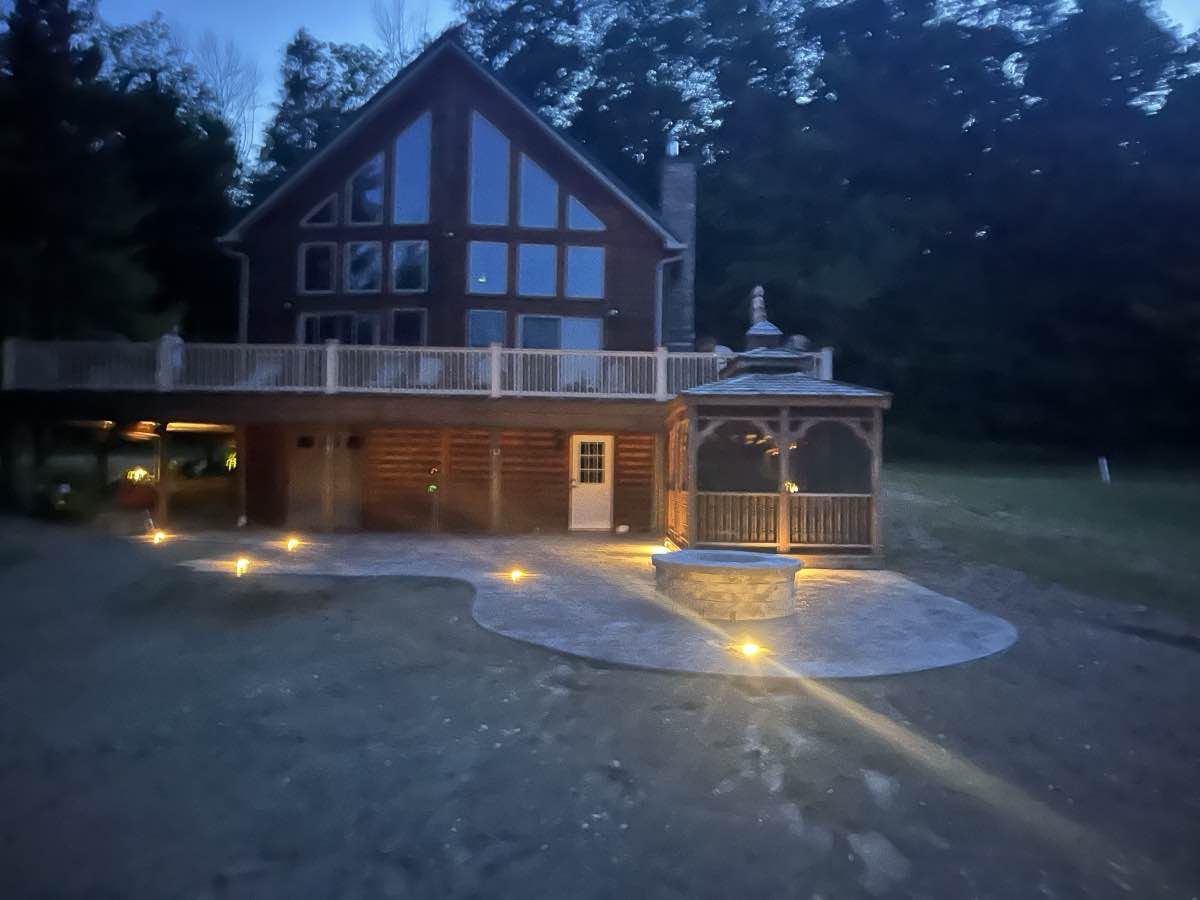 A cabin patio glowing at twilight