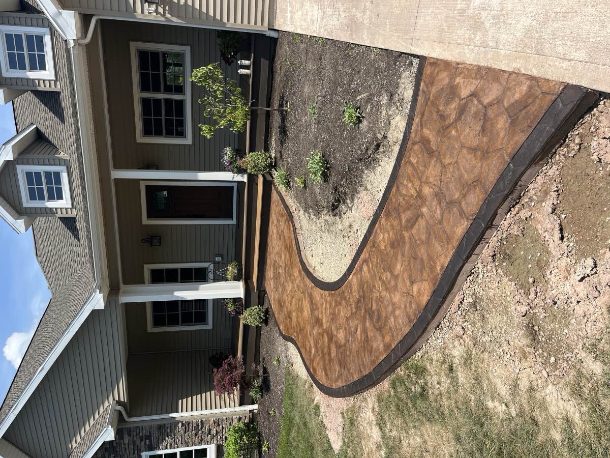A curved concrete walkway leading to a front entrance