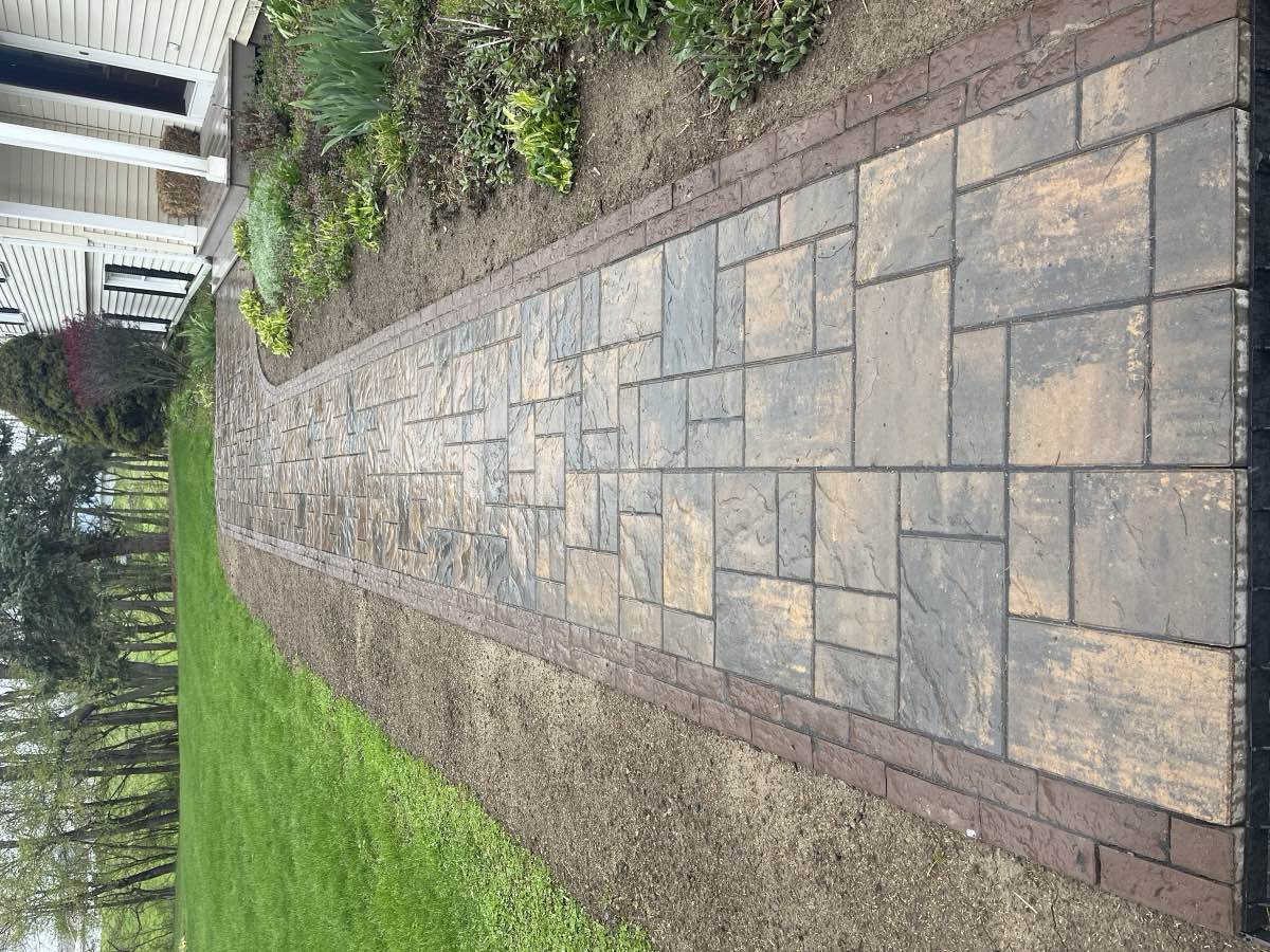 A paver walkway leading to a front porch